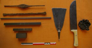 Material for traditionnal forge tests in Dogon Country (January 2008). Left : different kinds of iron used : ancient iron bars, modern bars with different sections. Center : a hoe a big knife. Right : a forge slag . Photo R. Soulignac